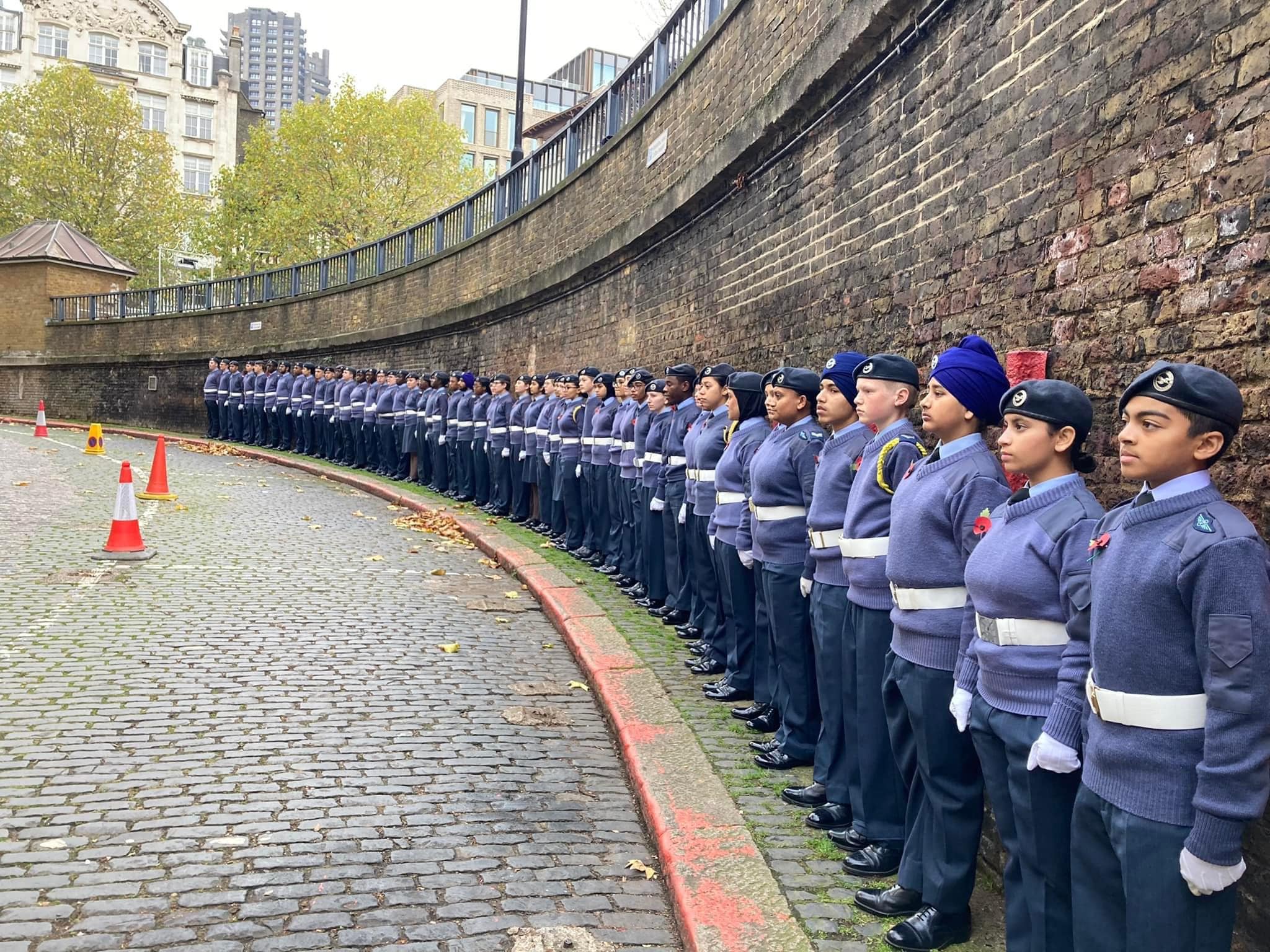 London Wing air cadets on parade at sunset with the London skyline behind them